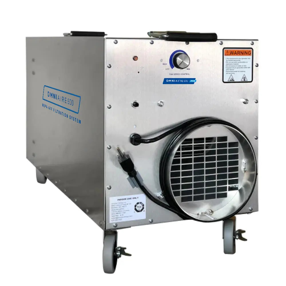 A portable OmniAire 600 negative air machine with HEPA filtration, featuring a silver metal body, black wheels, and control panel.