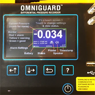 Omniguard differential pressure recorder with digital display and control buttons.