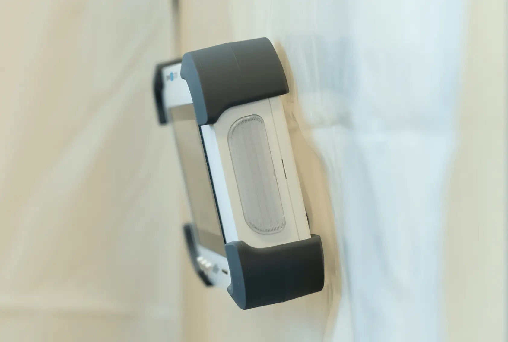 Close-up of Omni IQ G700 mounted on plastic sheeting hanging from wall