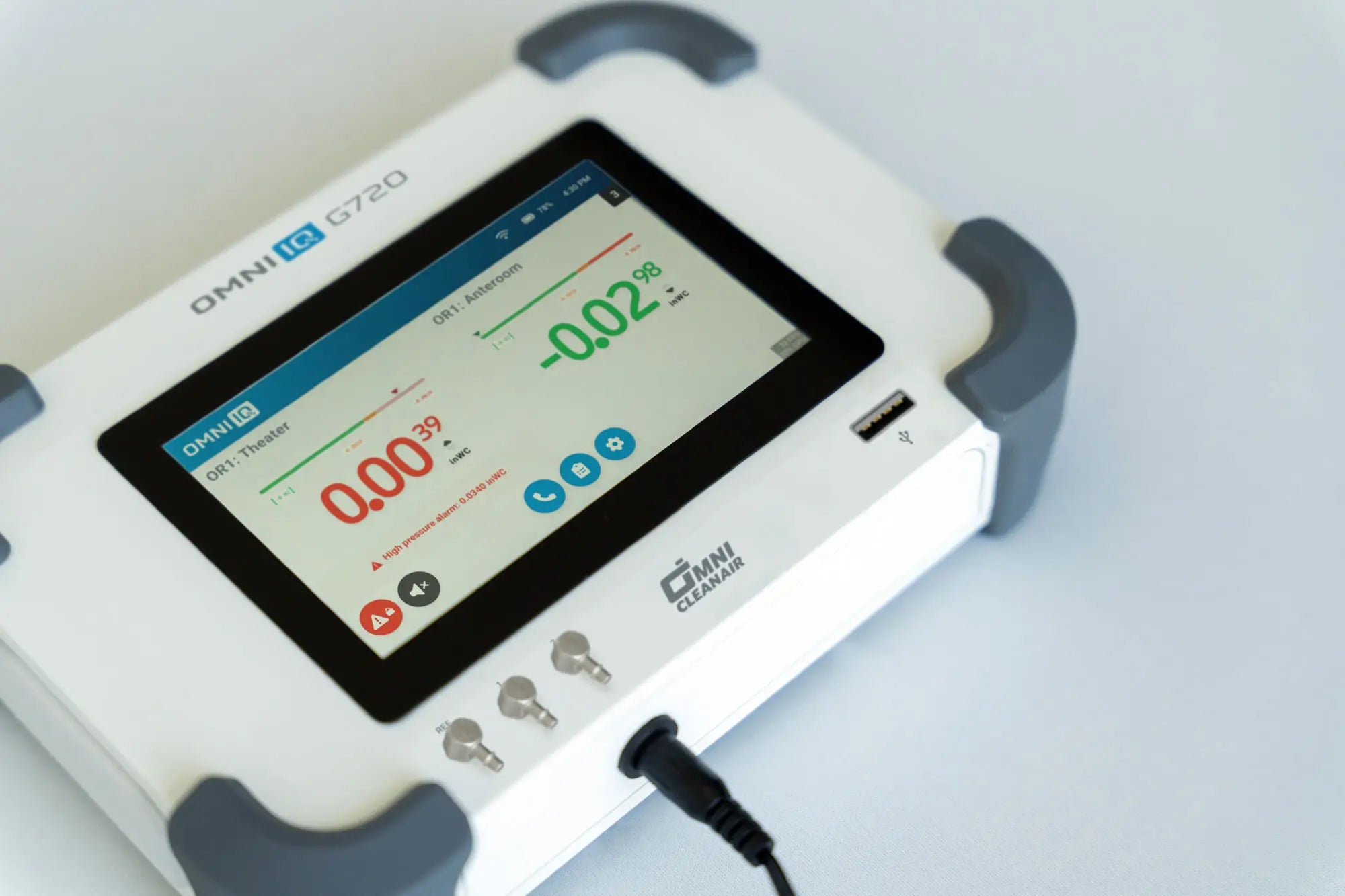 Omni IQ G720 device with digital display showing two active monitored zones